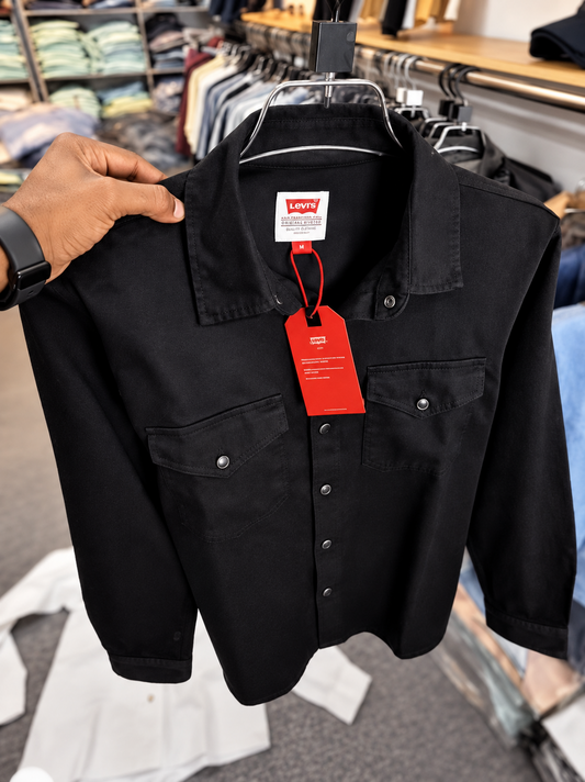 Black denim shirt held on hanger